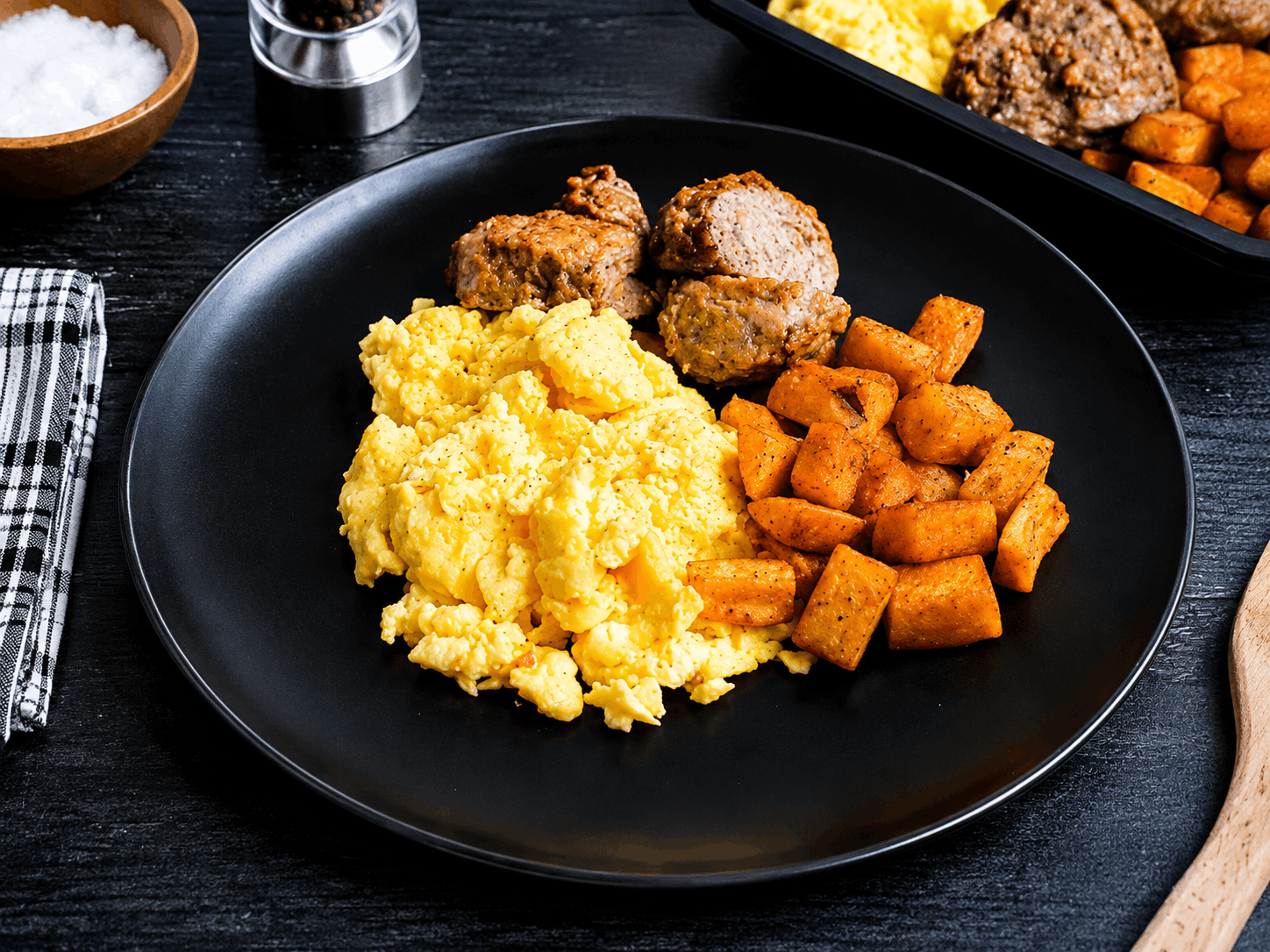 Fresh-ground, handcrafted chicken sausage patties seasoned to perfection and oven-finished, served alongside fluffy scrambled eggs and crispy roasted potatoes.