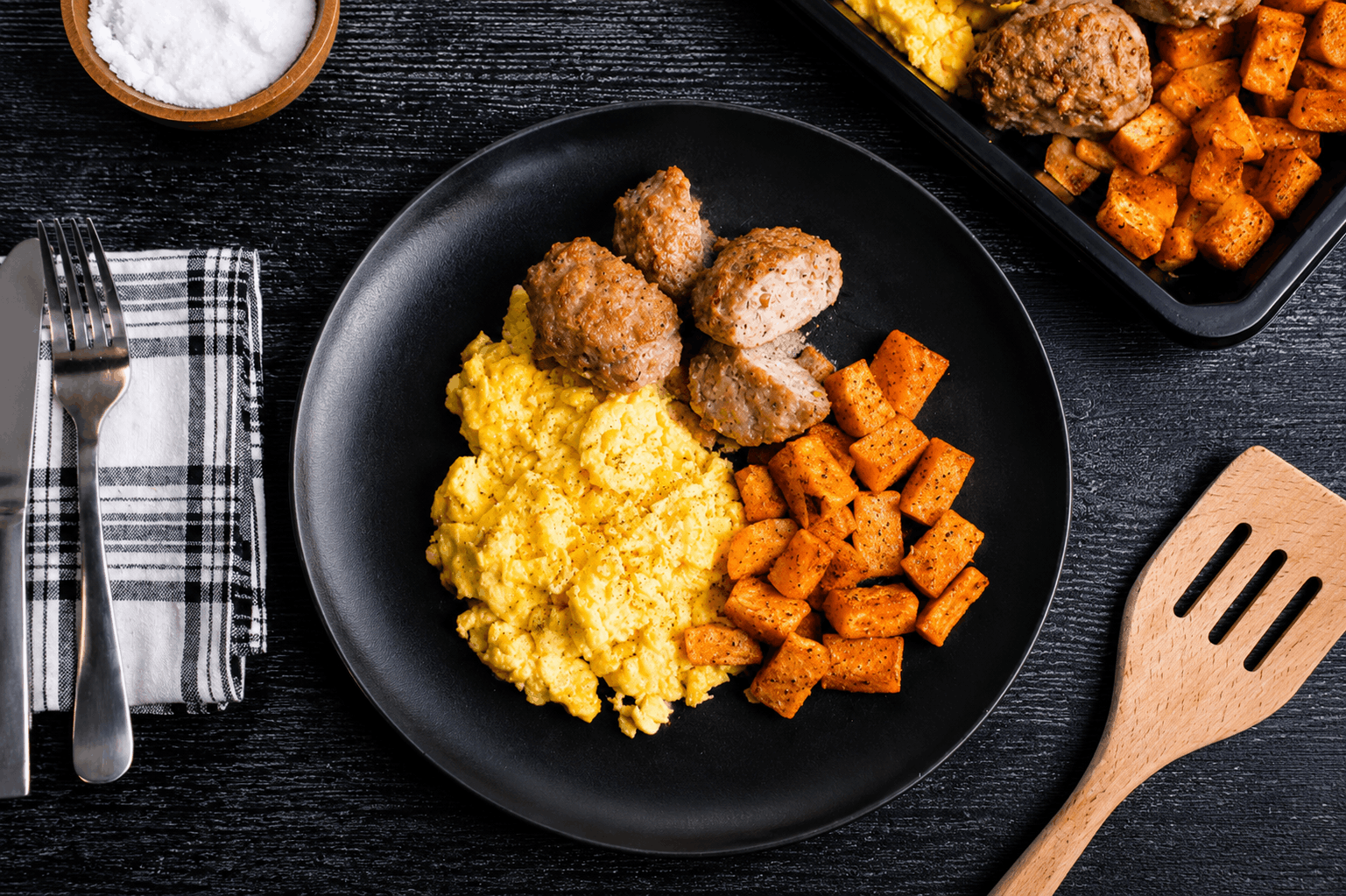 Fresh-ground, handcrafted chicken sausage patties seasoned to perfection and oven-finished, served alongside fluffy scrambled eggs and crispy roasted potatoes.