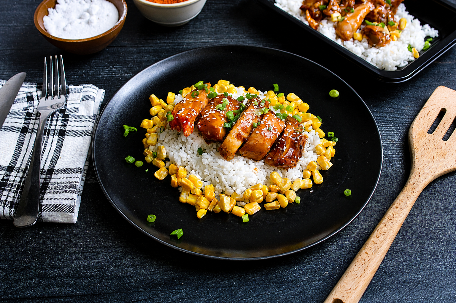 Juicy, hormone-free skinless chicken thighs tossed in our signature sweet-and-spicy bourbon glaze, served with jasmine rice, tender sweet corn, and topped with fresh scallions.
