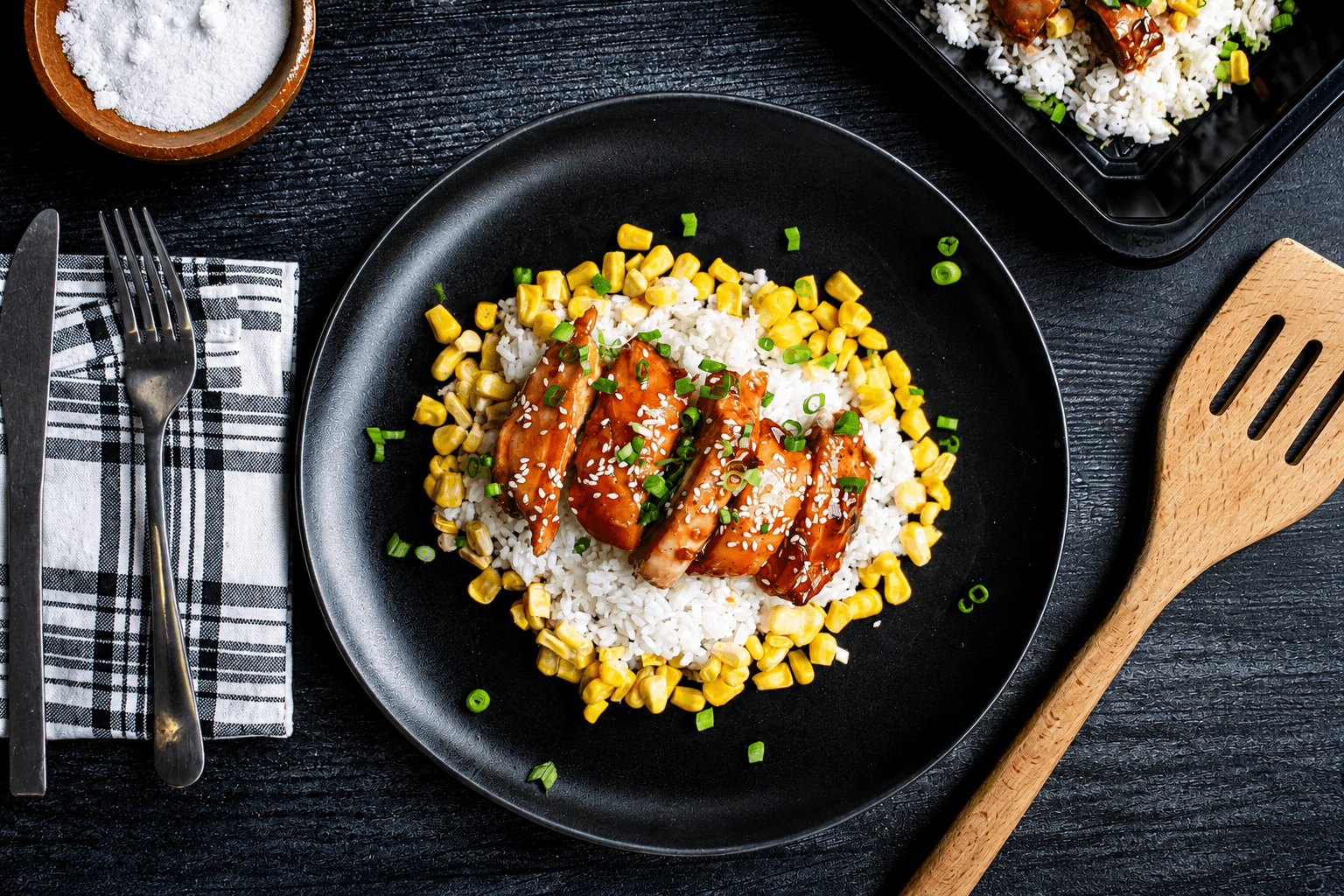 Juicy, hormone-free skinless chicken thighs tossed in our signature sweet-and-spicy bourbon glaze, served with jasmine rice, tender sweet corn, and topped with fresh scallions.