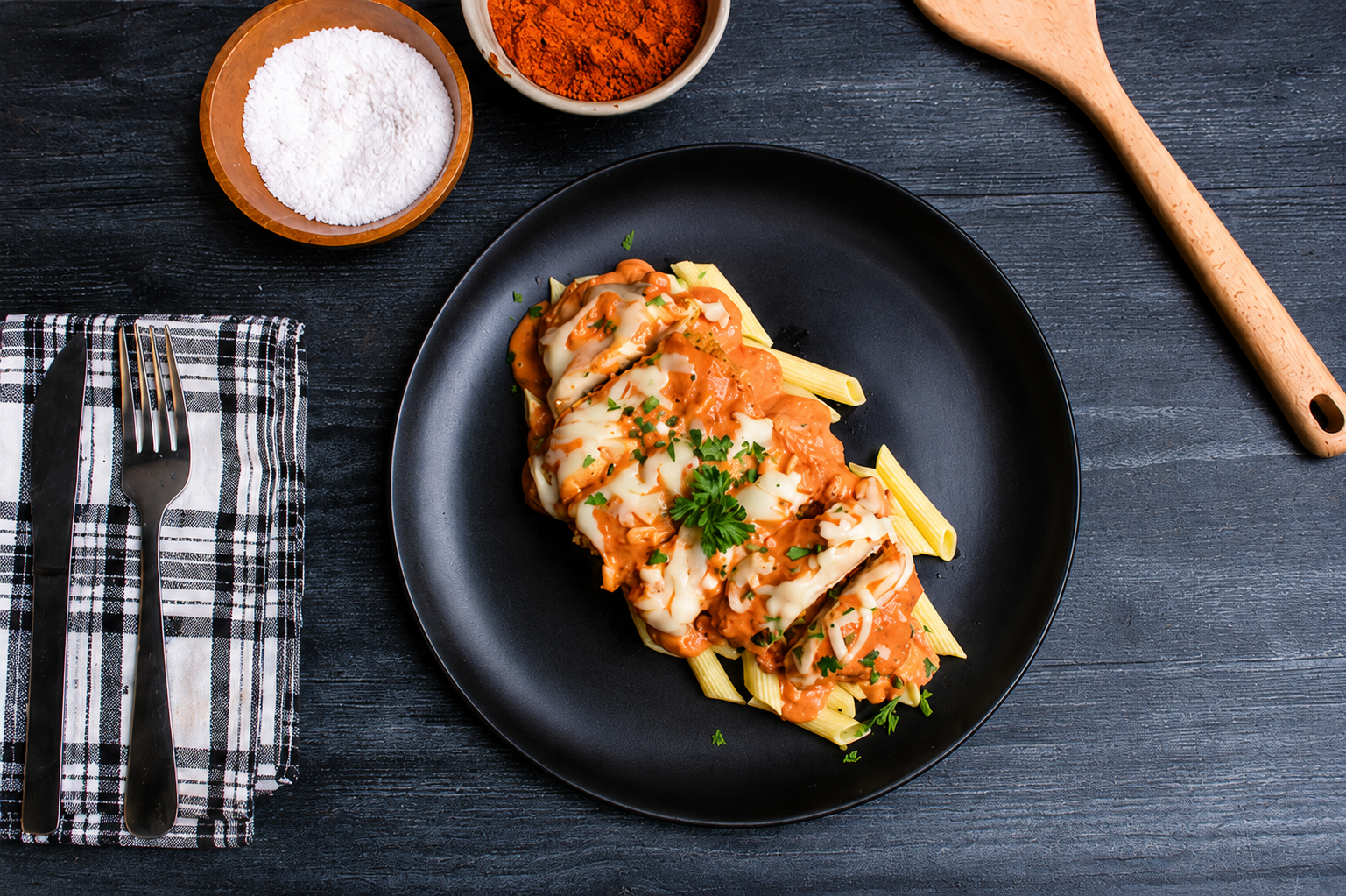 Crispy breaded chicken topped with creamy vodka sauce, melted mozzarella, and parmesan cheese, served over tender penne pasta for the perfect balance of comfort food flavor and clean ingredients.